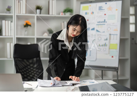 Accountant engaged in financial analysis and document review. Accountant engaged in financial analysis and document review. 123775127