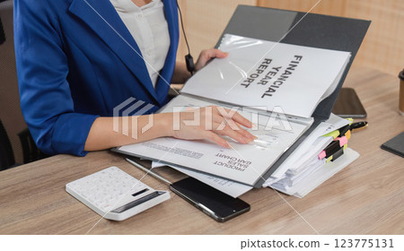 Accountant organizing financial reports and tax documents for clients Accountant organizing financial reports and tax documents for clients 123775131