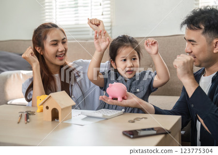 Family joyfully discussing saving strategies with piggy banks Family joyfully discussing saving strategies with piggy banks 123775304