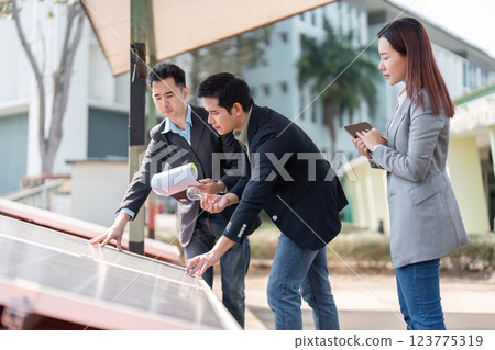 Sustainable business. Business consultants strategizing on solar energy implementation. 123775319