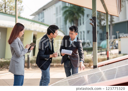 Sustainable business. Team reviewing solar technology for environmental impact. Sustainable business. Team reviewing solar technology for environmental impact. 123775320