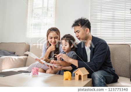Family budgeting session with a focus on savings and financial education. 123775340