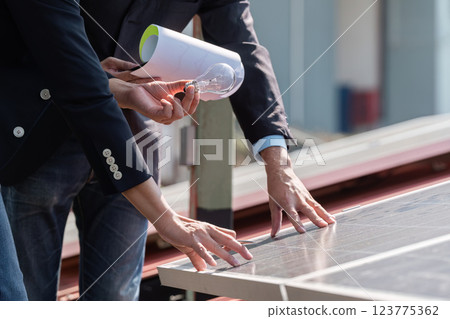 Sustainable business. Professionals collaborating on solar energy initiatives with a focus. 123775362