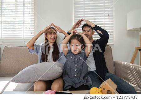 Family playing a fun game, creating a playful atmosphere at home. 123775435