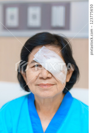 Elderly Woman with eye protective shield after eye surgery. Eye disease, Cataract, Glaucoma, Age Related Macular Degeneration, Diabetic Retinopathy, Vitreous, Lasik, World Glaucoma day and health Elderly Woman with eye protective shield after eye surgery. Eye disease, Cataract, Glaucoma, Age Related Macular Degeneration, Diabetic Retinopathy, Vitreous, Lasik, World Glaucoma day and health 123775650