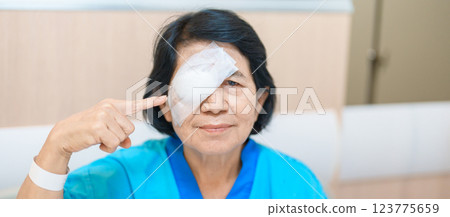 Elderly Woman with eye protective shield after eye surgery. Eye disease, Cataract,  Glaucoma, Age Related Macular Degeneration, Diabetic Retinopathy, Vitreous, Lasik, World Glaucoma day and health 123775659