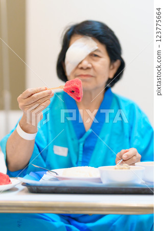 Senior Woman eating food after eye surgery in hospital . Eye disease, Cataract, Glaucoma, Age Related Macular Degeneration, Diabetic Retinopathy, Lasik, World Glaucoma day and health treatment Senior Woman eating food after eye surgery in hospital . Eye disease, Cataract, Glaucoma, Age Related Macular Degeneration, Diabetic Retinopathy, Lasik, World Glaucoma day and health treatment 123775664
