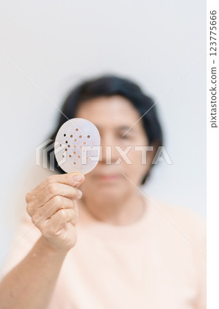 Elderly Woman with eye protective shield after eye surgery. Eye disease, Cataract, Glaucoma, Age Related Macular Degeneration, Diabetic Retinopathy, Vitreous, Lasik, World Glaucoma day and health Elderly Woman with eye protective shield after eye surgery. Eye disease, Cataract, Glaucoma, Age Related Macular Degeneration, Diabetic Retinopathy, Vitreous, Lasik, World Glaucoma day and health 123775666
