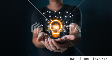 person hand holding power lightbulb and pretend to think, inspiration, creativity and imagination concept, innovation technology success business. Digital transformation. Ai technology. 123775684