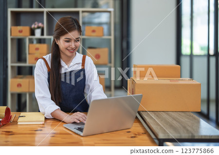 Excited young woman celebrating success while using computer laptop to see data delivery products customer profit Selling products of This month. Excited young woman celebrating success while using computer laptop to see data delivery products customer profit Selling products of This month. 123775866