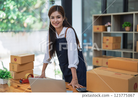 Excited young woman celebrating success while using computer laptop to see data delivery products customer profit Selling products of This month. Excited young woman celebrating success while using computer laptop to see data delivery products customer profit Selling products of This month. 123775867