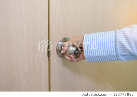 Woman hand holding doorknob and Open door. close the door knob Woman hand holding doorknob and Open door. close the door knob 123775982