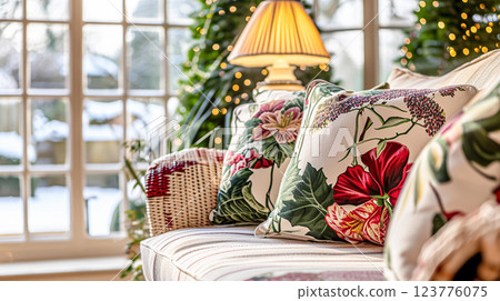 Colorful pillows on sofa against glass wall of window in a winter garden or conservatory. Interior textile concept. High quality photo 123776075