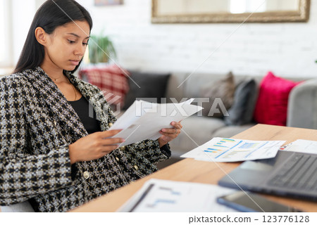 Woman sitting at desk studying online, learning remote working from home. Woman sitting at desk studying online, learning remote working from home. 123776128