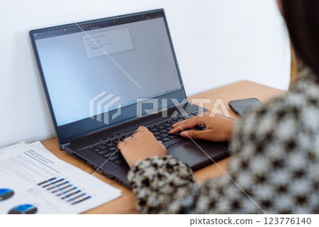 Woman sitting at desk typing remote working from home. Woman sitting at desk typing remote working from home. 123776140