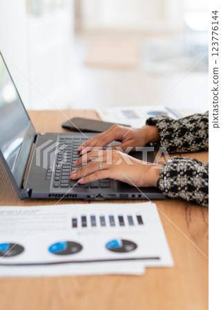 Female at desk with laptop computer freelance working 123776144