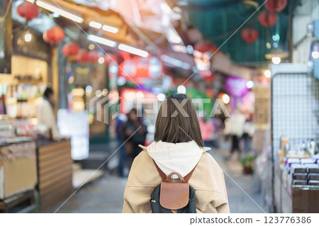 woman traveler visiting in Taiwan, female Tourist with backpack sightseeing and shopping at Jiufen Old Street market. Popular landmark and attractions near Taipei City. Travel and Vacation concept 123776386