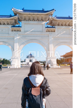 woman traveler visiting in Taiwan, female Tourist sightseeing at National Chiang Kai shek Memorial or Hall Freedom Square, Taipei City. Popular landmark and attractions. Asia Travel concept 123776399