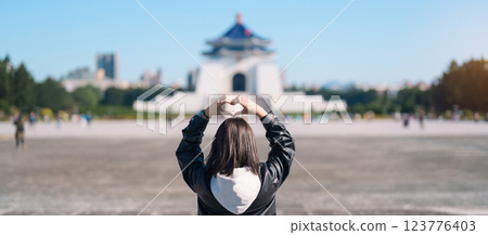 woman traveler visiting in Taiwan, female Tourist sightseeing at National Chiang Kai shek Memorial or Hall Freedom Square, Taipei City. Popular landmark and attractions. Asia Travel concept 123776403