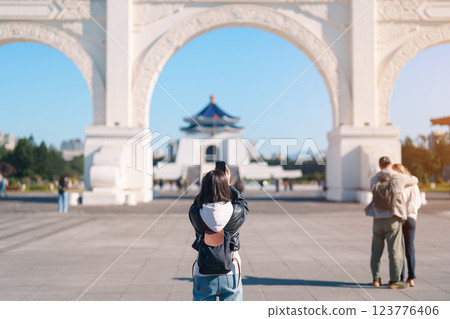 woman traveler traveling in Taiwan, female Tourist taking photo by mobile phone at National Chiang Kai shek Memorial or Hall Freedom Square, Taipei City. Popular landmark and attractions woman traveler traveling in Taiwan, female Tourist taking photo by mobile phone at National Chiang Kai shek Memorial or Hall Freedom Square, Taipei City. Popular landmark and attractions 123776406
