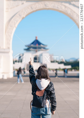 woman traveler visiting in Taiwan, female Tourist sightseeing at National Chiang Kai shek Memorial or Hall Freedom Square, Taipei City. Popular landmark and attractions. Asia Travel concept 123776407