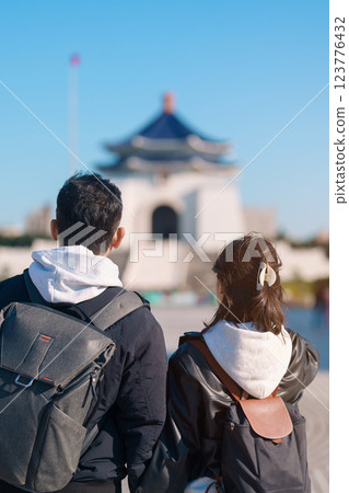 Couple traveler traveling in Taiwan, Tourists sightseeing at National Chiang Kai shek Memorial or Hall Freedom Square, Taipei City. Popular landmark and attractions. Asia Travel and vacation concept 123776432