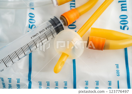 Foley catheter and urine drainage bag collect urine for disability or patient in hospital. 123776497
