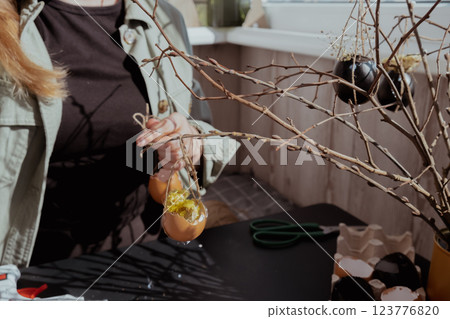 Unrecognizable woman creating Easter holiday decoration from egg shell. Diy do it yourself step by step instruction. Crafting preparation 123776820
