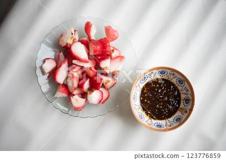 Sliced fresh water apples served with a traditional spicy sambal dip, 123776859