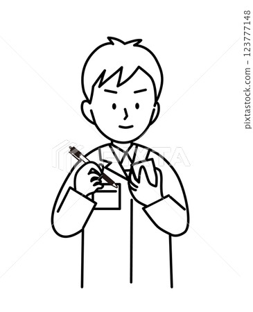 A young man in work clothes taking notes 123777148