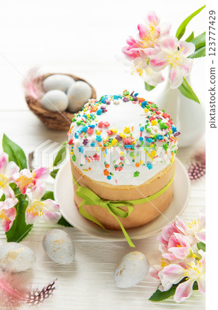Celebrating easter with a beautifully decorated cake, colorful eggs, and fresh flowers Celebrating easter with a beautifully decorated cake, colorful eggs, and fresh flowers 123777429