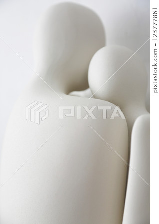 A ceramic object with the upper body motif of what appears to be a man and woman, photographed against a white background A ceramic object with the upper body motif of what appears to be a man and woman, photographed against a white background 123777861