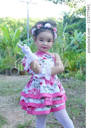 Asian little girl playing in the garden at the park on summer Asian little girl playing in the garden at the park on summer 123777941