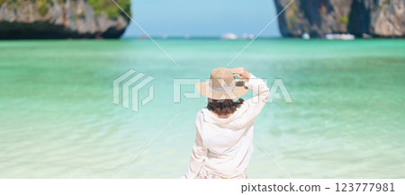 Woman tourist traveling and sightseeing in Krabi, Thailand, happy traveller enjoy at Maya Bay beach on Phi Phi island, Popular paradise island, destination, Southeast Asia Travel, vacation and holiday Woman tourist traveling and sightseeing in Krabi, Thailand, happy traveller enjoy at Maya Bay beach on Phi Phi island, Popular paradise island, destination, Southeast Asia Travel, vacation and holiday 123777981