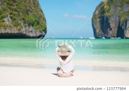 Woman tourist traveling and sightseeing in Krabi, Thailand, happy traveller enjoy at Maya Bay beach on Phi Phi island, Popular paradise island, destination, Southeast Asia Travel, vacation and holiday 123777984