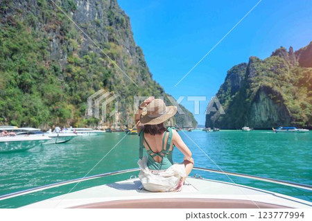 Woman tourist on boat trip, happy traveller relaxing at Pileh lagoon on Phi Phi island, Krabi, Thailand. Exotic landmark, destination Southeast Asia Travel, summer vacation and holiday concept Woman tourist on boat trip, happy traveller relaxing at Pileh lagoon on Phi Phi island, Krabi, Thailand. Exotic landmark, destination Southeast Asia Travel, summer vacation and holiday concept 123777994