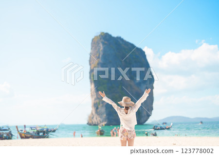 Woman tourist traveling and sightseeing in Krabi, Thailand. happy traveller enjoy on beach at Koh Poda island. summer trip, destination, Southeast Asia Travel, vacation and holiday concept 123778002