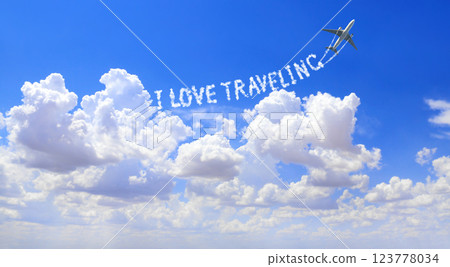 Blue sky with aircraft and Jet trailing smoke. Horizontal banner with airplane drawing a word I love traveling in sky. Topic of summer holiday, travel, trip abroad on vacation, cruises and tours 123778034
