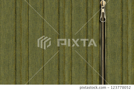Dark green denim background with zipper. Khaki color denim jeans fabric texture and close zip. Decorative backdrop with zipper or fastener, khaki-colored jeans fabric material. Copy space for text 123778052