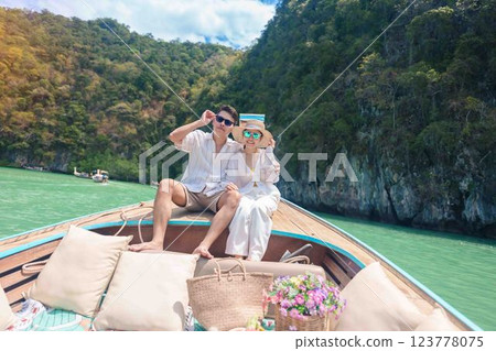 Happy couple tourist in private longtail boat trip to koh Hong lagoon island at Krabi, Thailand. Honeymoon, tropical destination, southeast Asia Travel, summer vacation and wanderlust concept 123778075