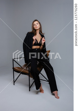 Businesswoman removing jacket sitting on chair with closed eyes Businesswoman removing jacket sitting on chair with closed eyes 123778260