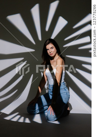 Fashion model posing with creative lighting creating striped shadows Fashion model posing with creative lighting creating striped shadows 123778266