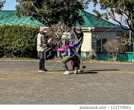 Elderly people enjoying grand golf in the park 123778663