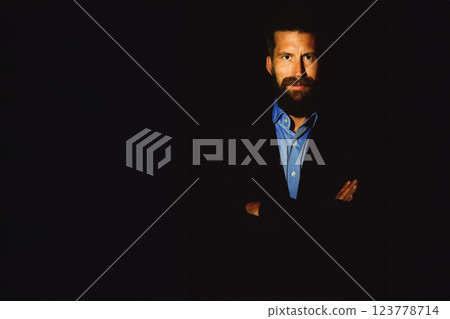 Portrait of man with beard and mustache black jacket blue shirt 123778714