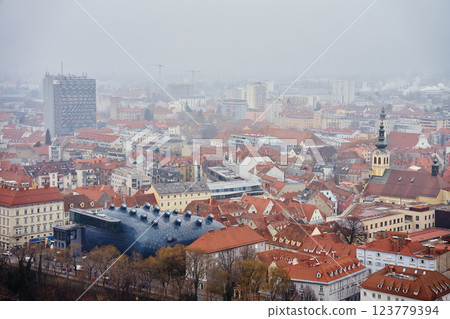 Graz cityscape on foggy day. Panoramic view of Graz, Austria with historical architecture. Streets with red roofed buildings in European city 123779394