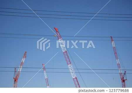 A construction site crane visible beyond the power lines 123779686