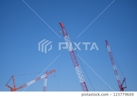 Blue sky and construction site cranes 123779689