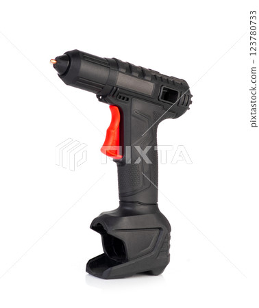 Cordless hot glue gun isolated on a white background. Black and red ergonomic design Cordless hot glue gun isolated on a white background. Black and red ergonomic design 123780733