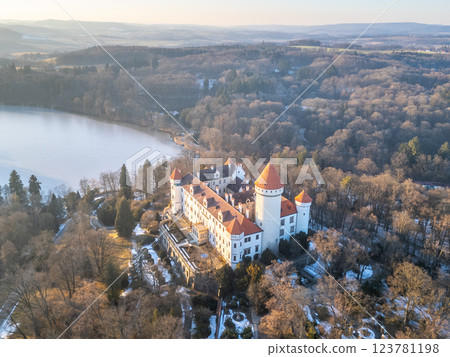 Konopiste Castle sits majestically in Czechia, surrounded by lush forest and a serene lake. The aerial perspective showcases its historic architecture and beautiful landscape at sunset. Konopiste Castle sits majestically in Czechia, surrounded by lush forest and a serene lake. The aerial perspective showcases its historic architecture and beautiful landscape at sunset. 123781198