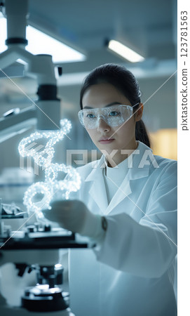 biotechnologist in genetics lab examining DNA samples with focus and precision 123781563